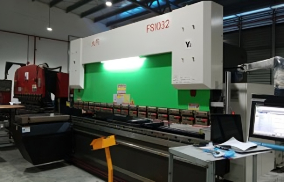 FS1032 press brake machine in an industrial setting, used for metal bending and fabrication.